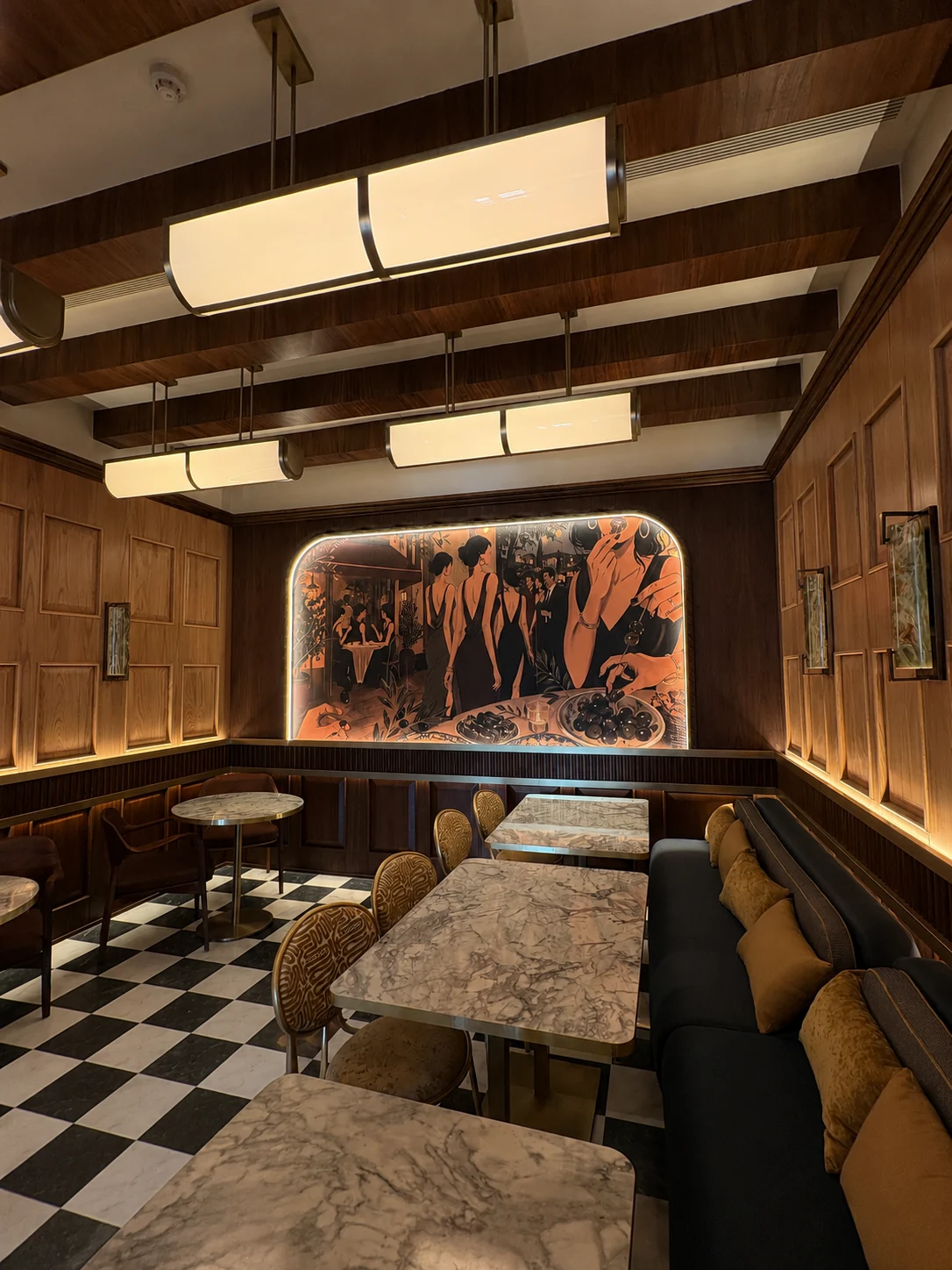 OLEV’s illustrated wall mural, marble tables and upholstered booths
